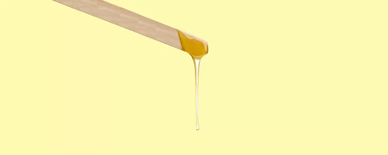 sugar wax dripping from a spatula