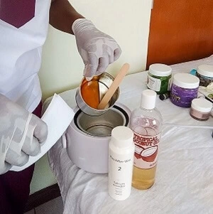 Sugar wax, strips, coconut oil, & talcum powder; materials used by Vivian, an esthetician with Viv's in-Houz Spa, a mobile waxing service in Nairobi